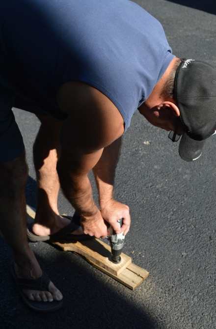 Lee drilling holes in driveway in flip flops.  Don't do this!
